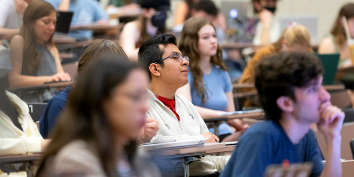 Students sitting in a large classroom in the Lecture Hall photo