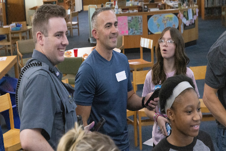 Officer Shane Robinson (left) and Lt. Steven Faulkner Jr., both with New York State University Police at Binghamton, with students at West Middle School in Binghamton in June 2022, as part of the Youth & Police Initiative (YPI) program.
