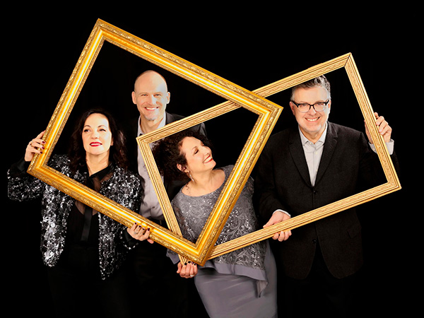 New York Voices The members New York Voices holding a golden frame.