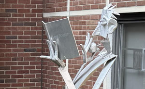 An aluminum sculpture by William King titled Forbidden Fruit