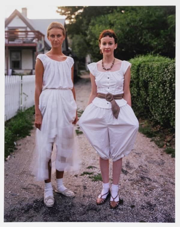 Two women standing next to each other in all white in Provincetown