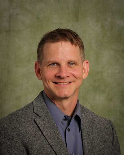 headshot of Adam Laats