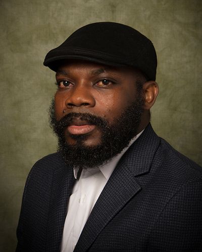 headshot of D.M. Aderibigbe