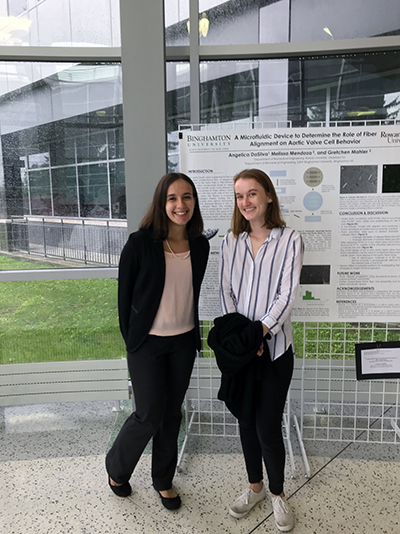 students in front of research poster