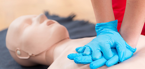 Someone giving compressions to a dummy photo