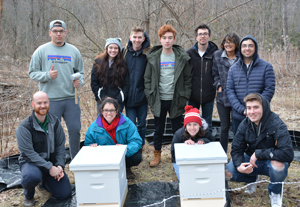 Eden Nebel and fellow Binghamton University Bee Club members visit the campus bee farm