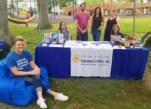Liberty and members of the CVAC team table at a Stand for Children event during the summer of 2019.