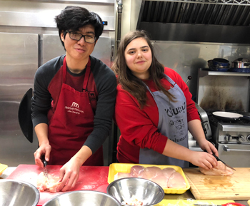 Hinman PLSC students Jerry Sheng and Carrie Tuczinski prepare a meal at the Rescue Mission.