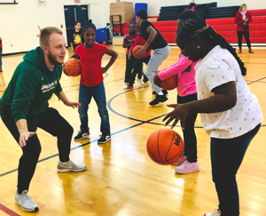 Patrick Norris, coordinator of player development at Binghamton University Men’s Basketball, plays defense during recess.