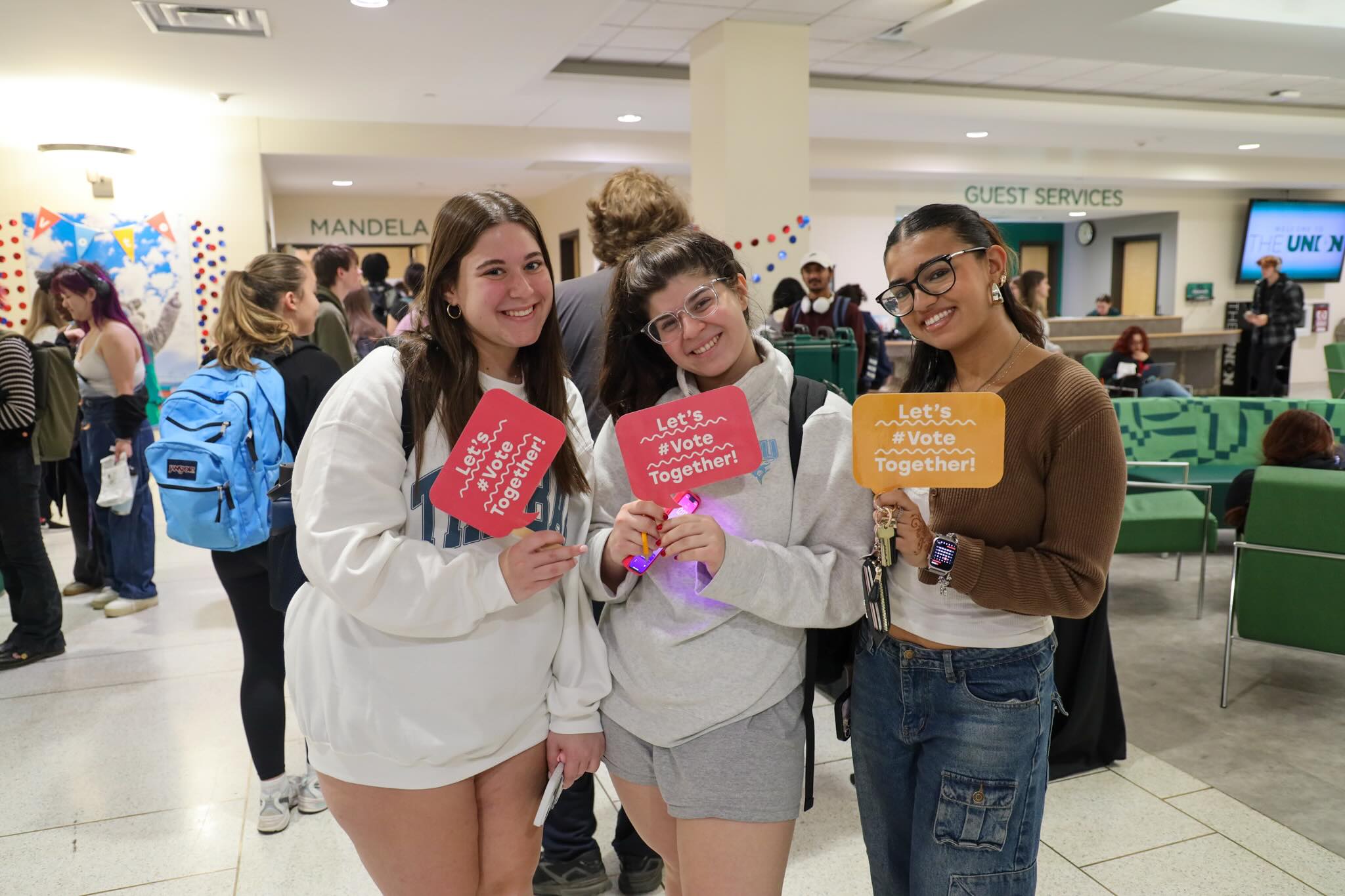 Students pose outside of the Mandela Room on campus on election day.