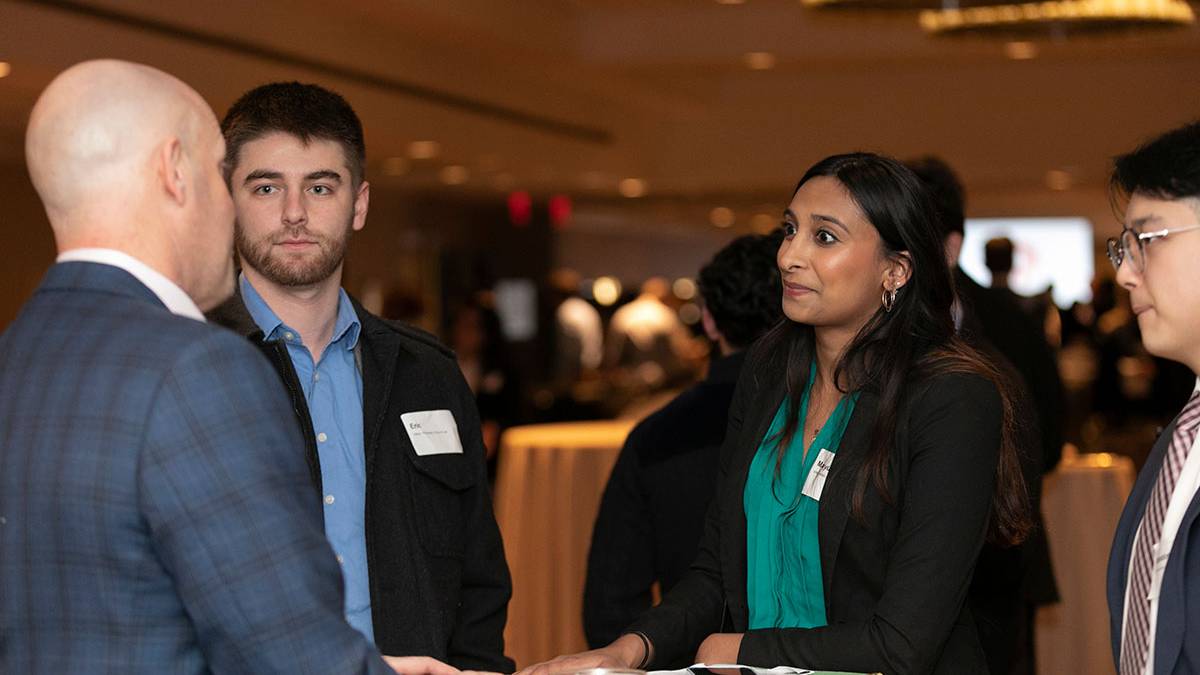 Binghamton students talking with an alumni