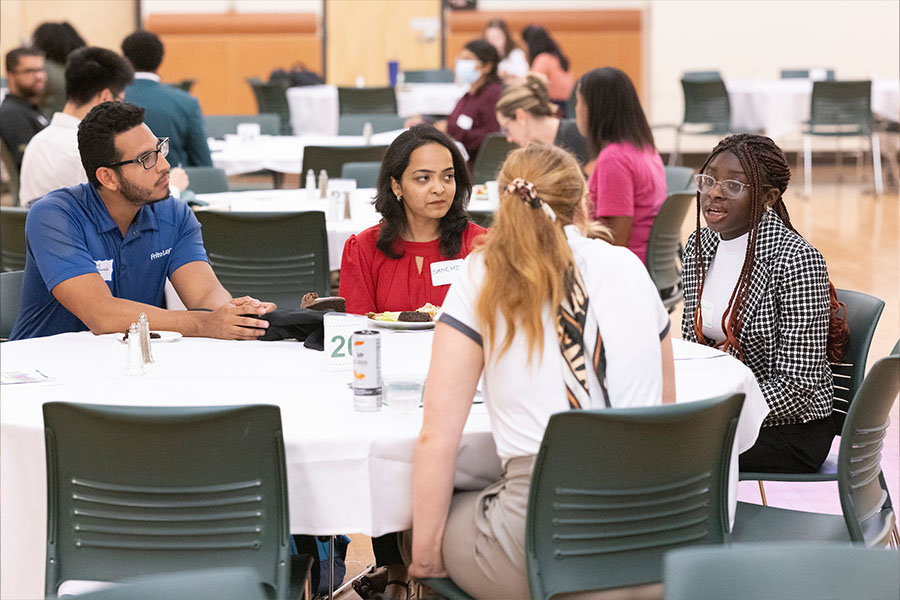 Students and employers talking at a table