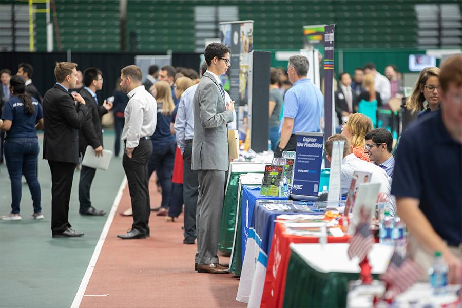 Student talking to employer at the Fall Job and Internship Fair