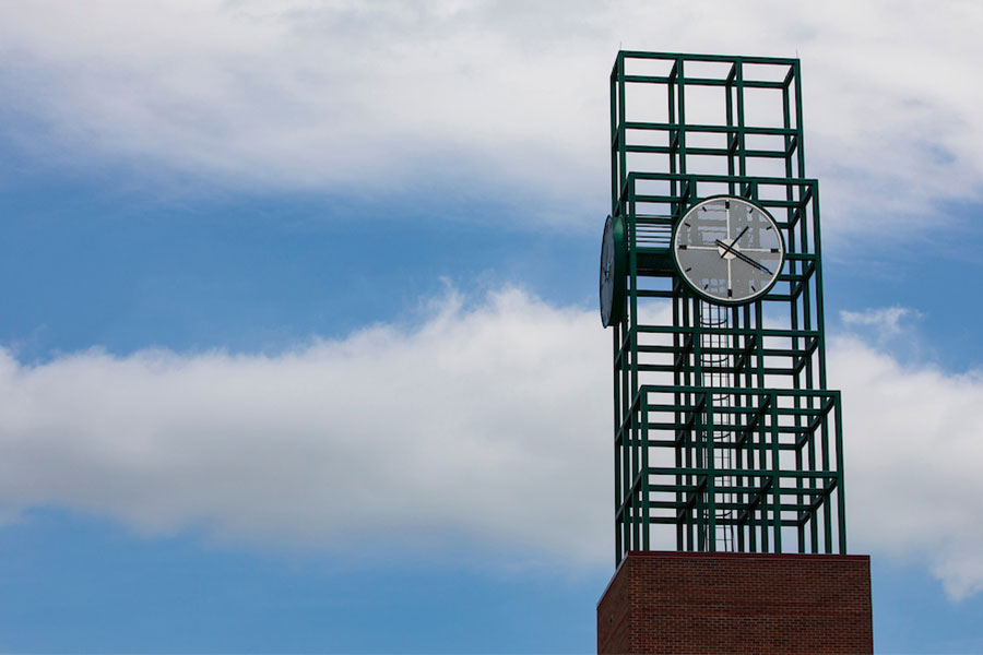 Binghamton University's clock tower, against a blue sky with a few clouds. photo