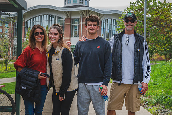 A family standing outside of C4 Dining Hall. photo