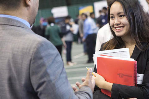 Student speaking with an employer at the Job and Internship fair