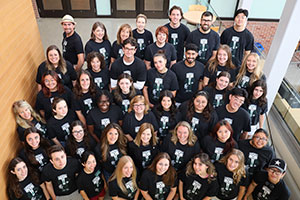 Team photo that features the staff in black t-shirts. photo