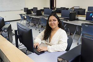 Student sitting at a computer. photo
