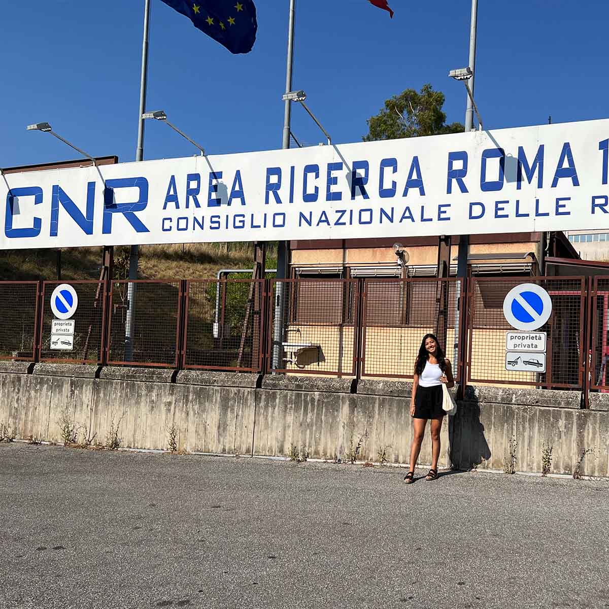 A girl standing in outside the Italian Council of National Research