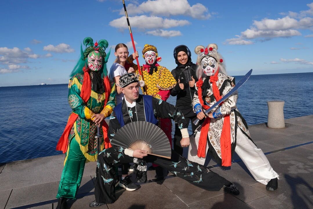 Group photo of performers and participants posing by Dania Waterfront Park.