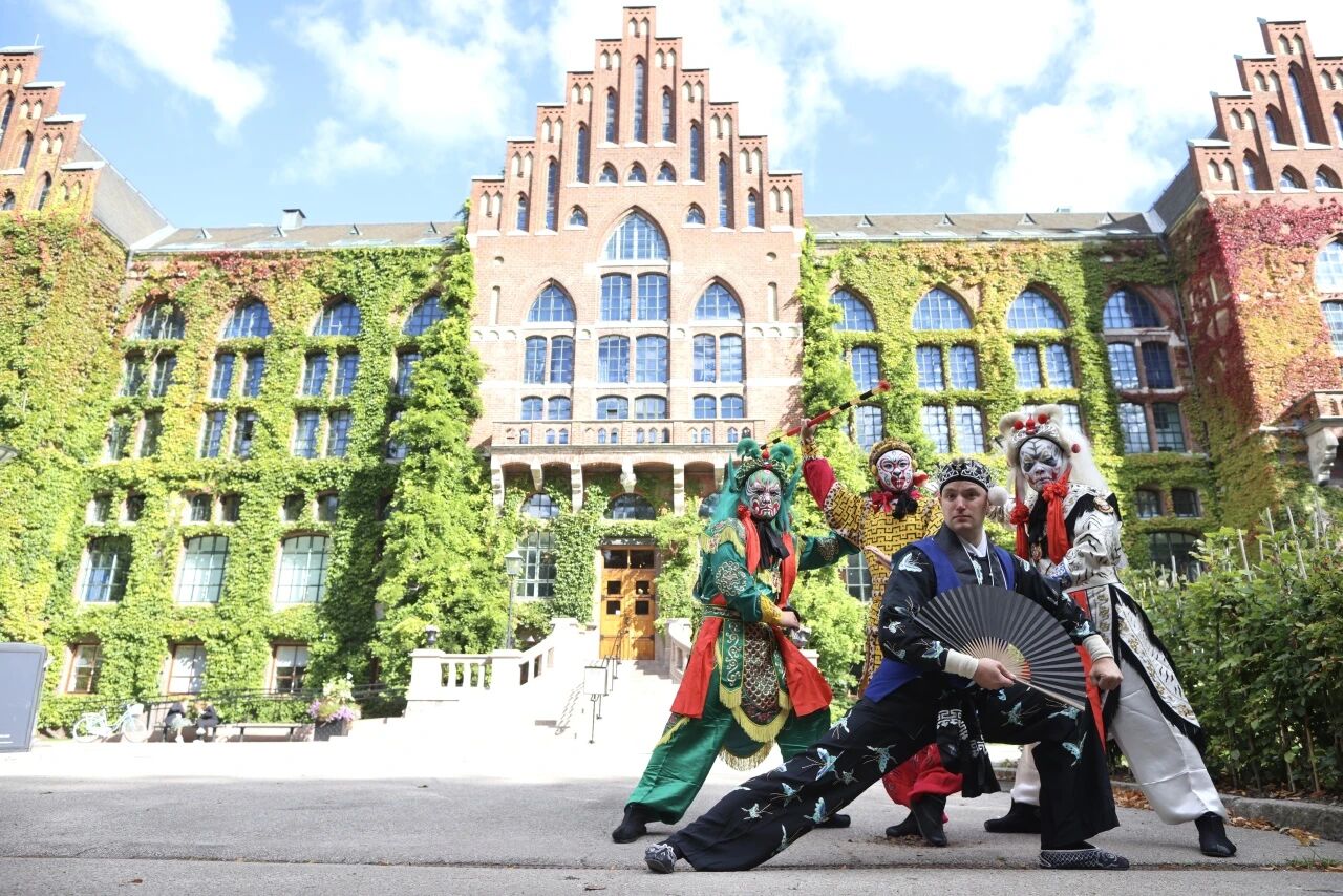 Four performers pose in front of Lund University