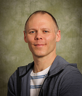 a studio headshot of David Biddle