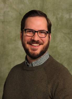 person with short brown hair headshot