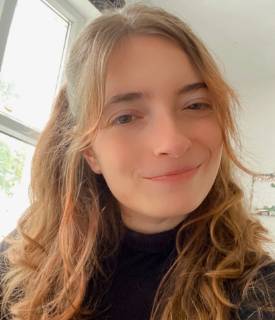 A picture of a smiling white person looking directly into the camera.