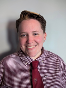 A picture of a smiling white person looking directly into the camera.