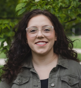 A picture of a smiling white person looking directly into the camera.
