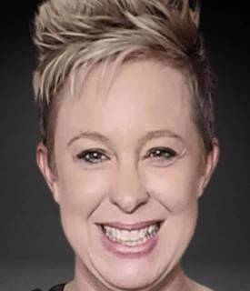 A picture of a smiling white person looking directly into the camera.