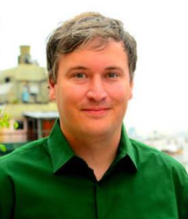 A picture of a smiling white person looking directly into the camera.