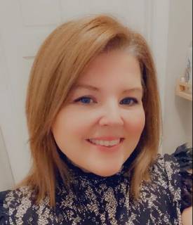 A picture of a smiling white person looking directly into the camera.