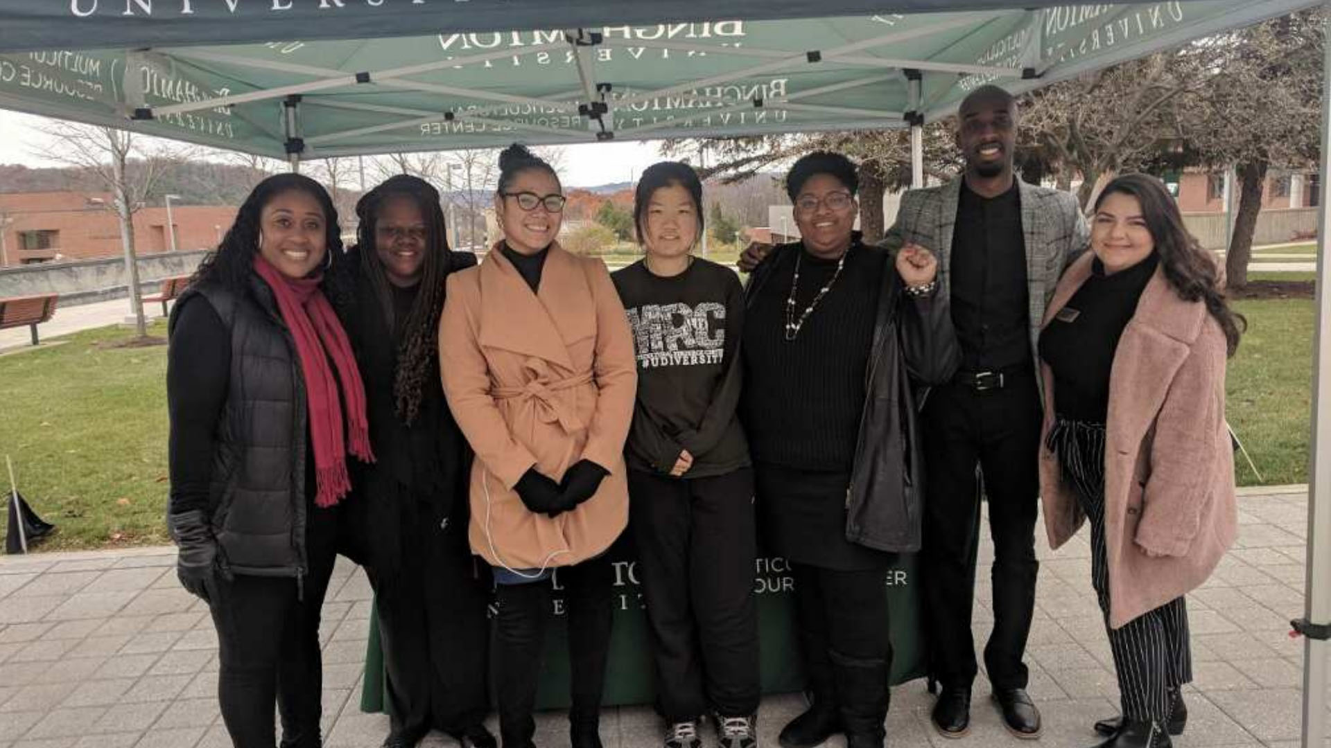 Professional Staff posing under the MRC tent at a Black Solidarity Day event