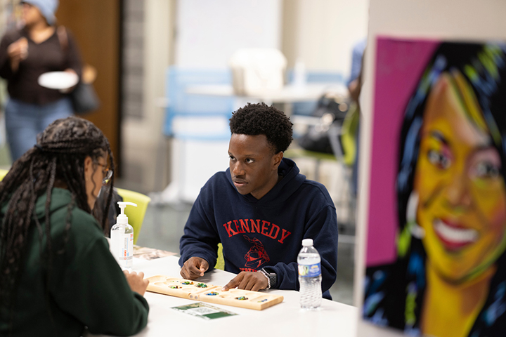 Two students working on an art project in the lounge.
