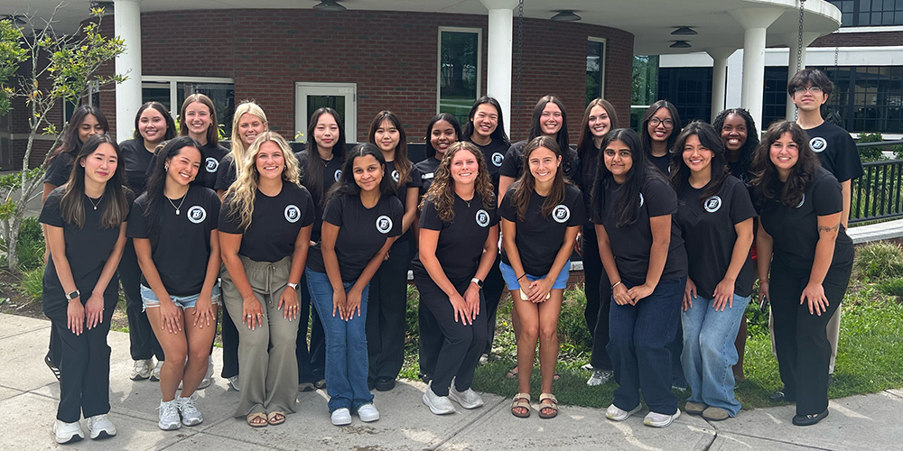 A group peer advisors standing outside the Health Sciences Building.