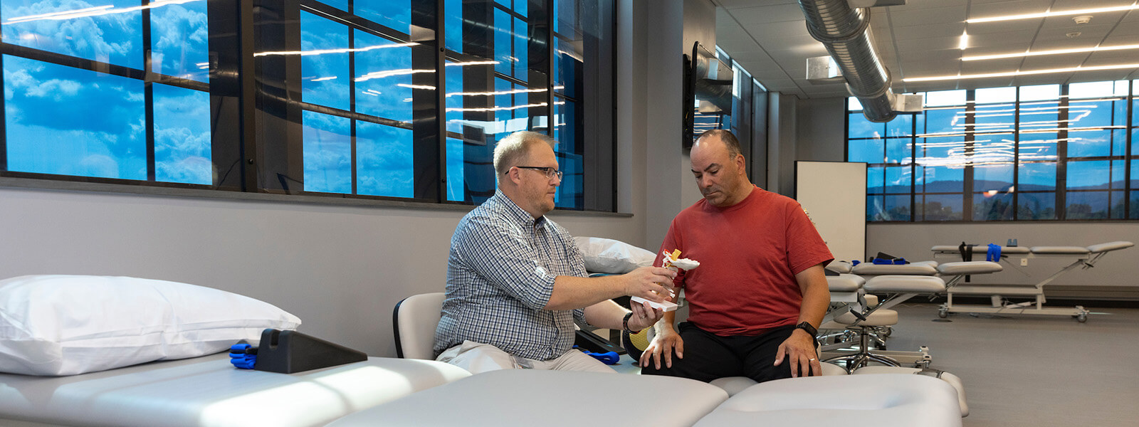 PT showing vertebrae to man photo