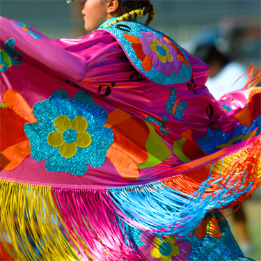 A ative American woman in brightly colored clothing
