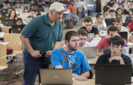 James B. Bankoski ’91 assisting students competing in the first-ever Google Games at Binghamton University in September 2017. About 220 students formed teams of five to participate in the puzzle-solving competition that involved coding and word association games.