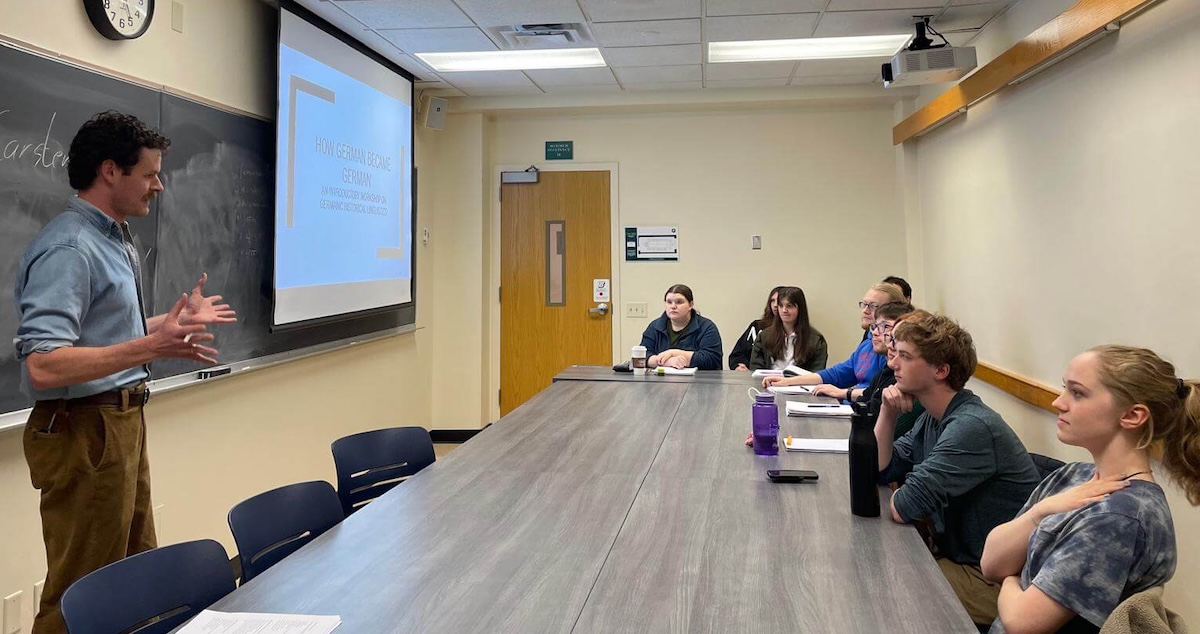A scholar of Germanic linguistics leading a workshop for students on historical linguistics.