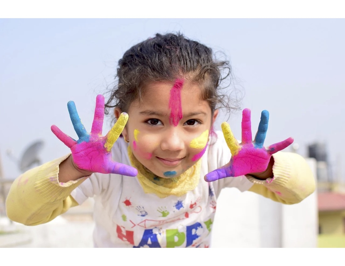Girl with painted colorful hands