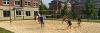 Scholars play volleyball outside of Broome Hall.