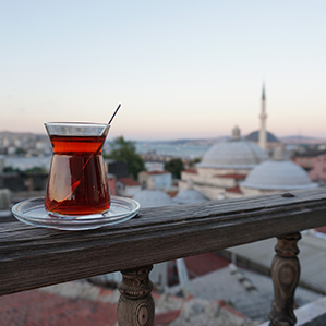 A view of the Istanbul skyline with a cup of Turkish tea in the foreground