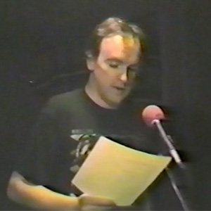 Richard Martin reads a selected poem on stage at Swat Sullivan's Hotel in Binghamton