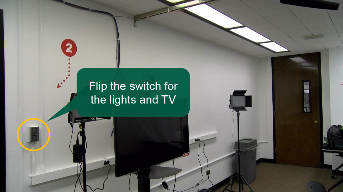 Step 2: Turn on light switch 2, located to the left of the television