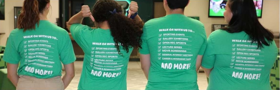 Four students with their backs facing the camera pointing to t-shirts that describe all of the events that students can be escorted to
