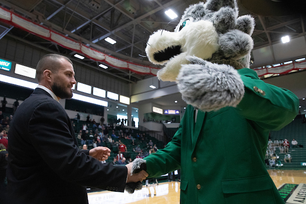 Baxter shakes hands with a 2018 Athletics Hall of Fame Inductee