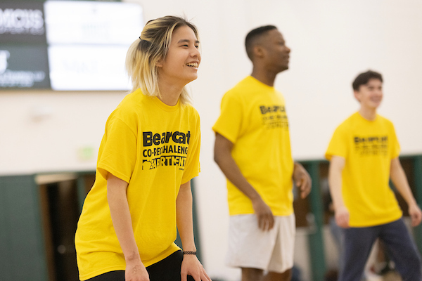 Students in yellow team shirts during a co-rec event