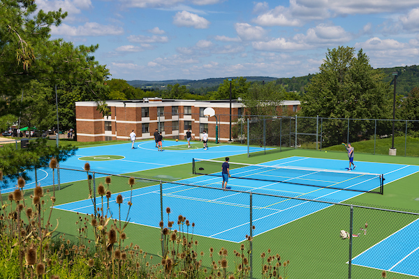 Students play on the basketball and tennis courts near the Hinman and Mountainview communities