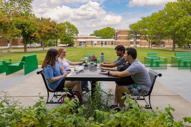 Students at an outdoor table at Hinman Dining Hall